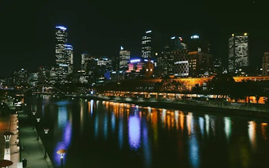 Melbourne city skyline at night reflected in the Yarra River for self-guided exploration game.