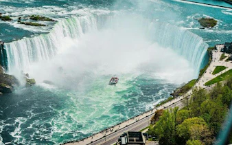 Boat cruising near Horseshoe Falls on a guided tour, Niagara Falls, Canada.