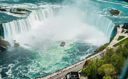 Boat cruising near Horseshoe Falls on a guided tour, Niagara Falls, Canada.