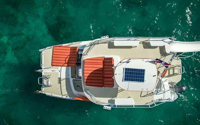 Catamaran on turquoise water, part of Punta Cana adventure tour with snorkeling and cenote access.