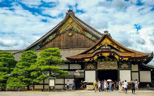 Nijo Castle entrance with tourists during Kyoto early morning guided tour.