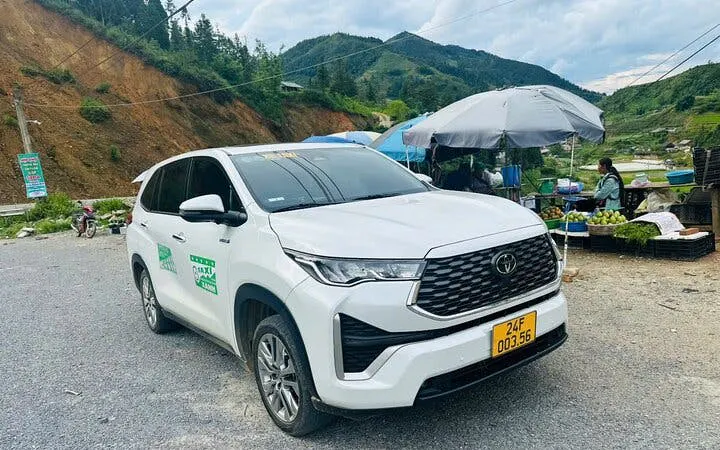 Private car parked on a scenic roadside in a mountainous area, available for full-day rental with driver.
