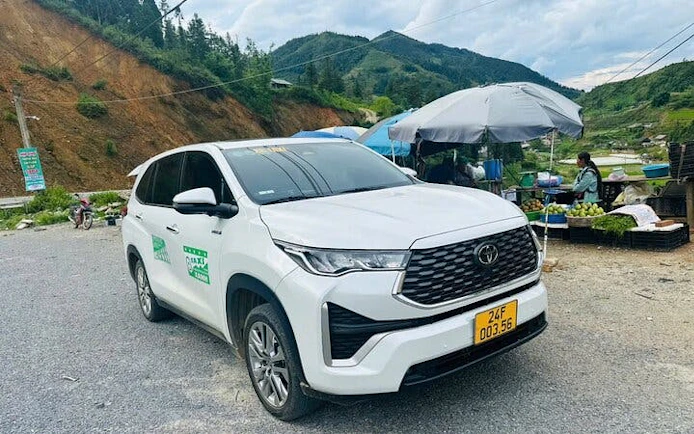 Private car parked on a scenic roadside in a mountainous area, available for full-day rental with driver.