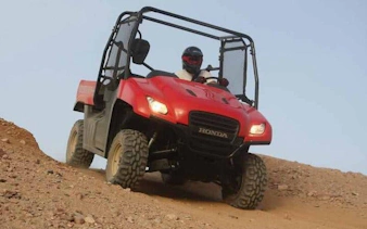 Buggy driving on desert terrain during sunrise or sunset in Sharm El Sheikh.