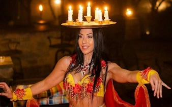 Performer balancing candles during cabaret night show in Hurghada.