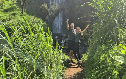 Couple posing on a lush path near Materuni Waterfall, Arusha, Tanzania.