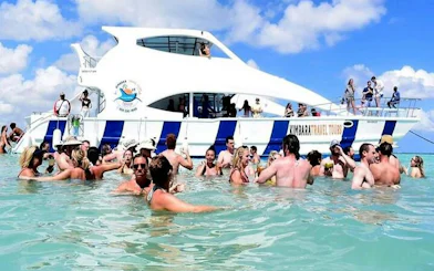 Tourists enjoying a snorkeling boat cruise with open bar in Punta Cana's natural pool.