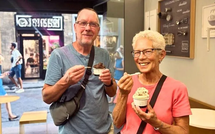 Couple enjoying gelato in a Florence shop during Oltrarno Artisan Walking Tour.