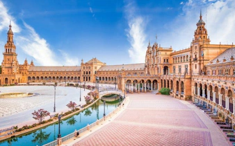 Plaza de España in Seville with canal and historic architecture on a sunny day.