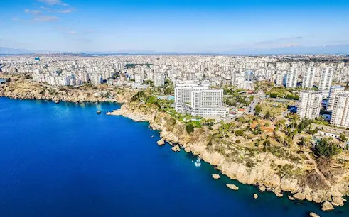 Aerial view of Antalya coastline with cityscape and cliffs, Turkey.