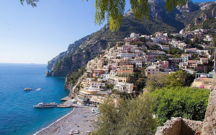 Amalfi Coast cliffside village with colorful buildings overlooking the sea, part of a small group tour.
