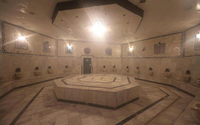 Turkish bath interior with marble seating and central platform in Hurghada spa.