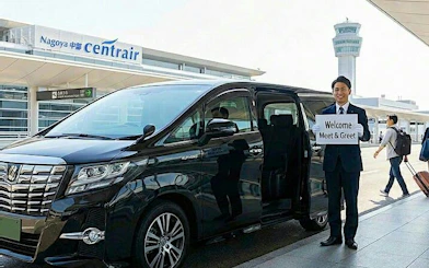 Private transfer service at Fukuoka Airport with driver holding welcome sign.