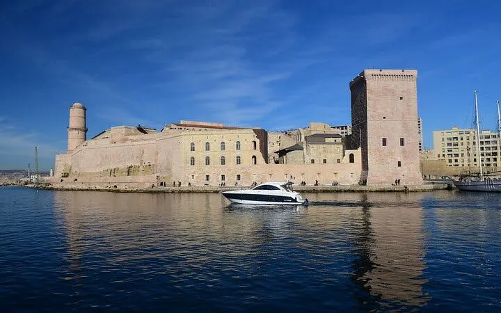 Fort Saint-Jean by the sea in Marseille with a boat in the foreground.