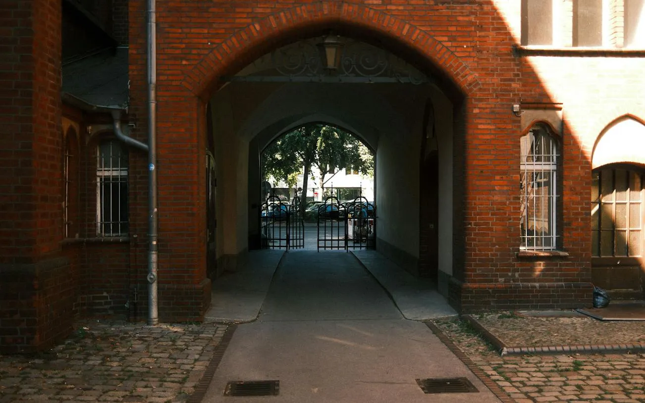Brick archway leading to a courtyard in Kreuzberg, Berlin.
