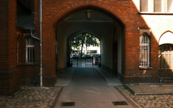 Brick archway leading to a courtyard in Kreuzberg, Berlin.