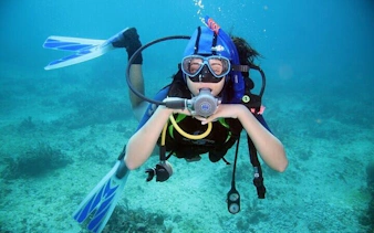 Diver exploring coral reef during Tiran Island snorkeling trip, Sharm El Sheikh.