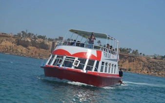 Glass-bottom boat on the Red Sea near Sharm El Sheikh with passengers enjoying the view.
