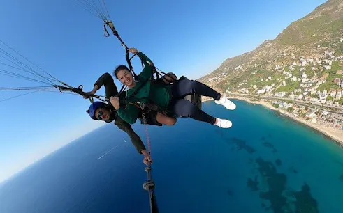from side: tandem paragliding with licensed pilot and hotel pickup-1