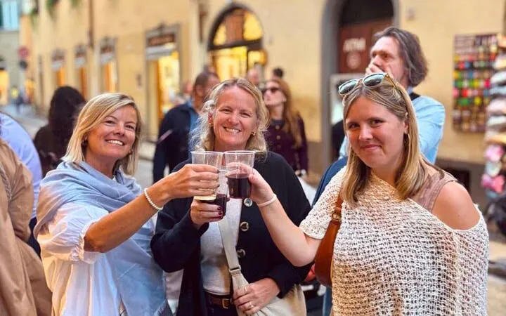 Group enjoying wine on Oltrarno Artisan Walking Tour in Florence.
