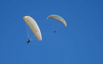 Paragliders soaring over Atlas Mountains near Marrakesh.