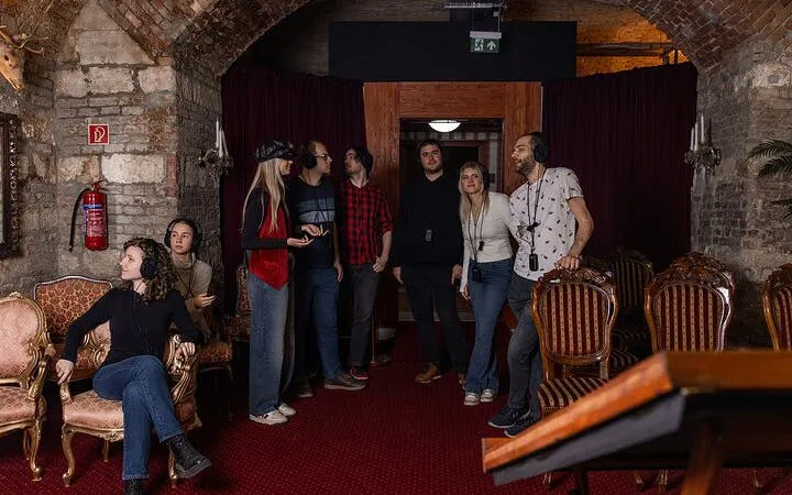 Visitors exploring Time Machine Budapest exhibition with VR headsets in a historic brick room.