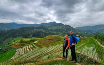 Mu Cang Chai rice terraces with two people on a motorbike tour in Vietnam.