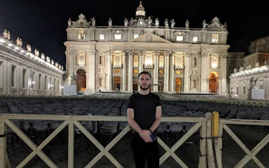 St. Peter's Basilica illuminated at night, Rome city exploration game location.