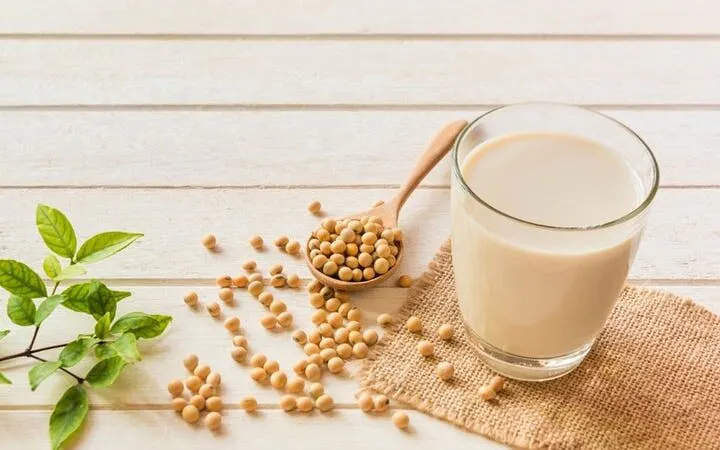Soybeans and soy milk on a wooden table, ingredients for Sa Pa tofu-making class.