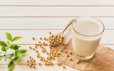 Soybeans and soy milk on a wooden table, ingredients for Sa Pa tofu-making class.