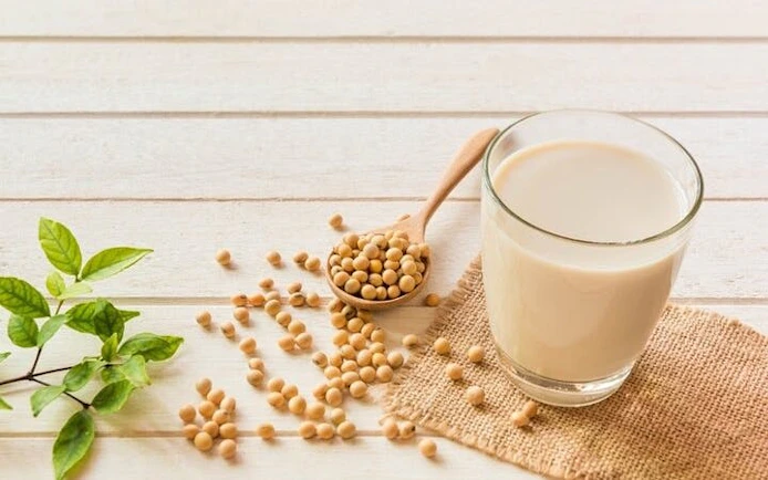 Soybeans and soy milk on a wooden table, ingredients for Sa Pa tofu-making class.