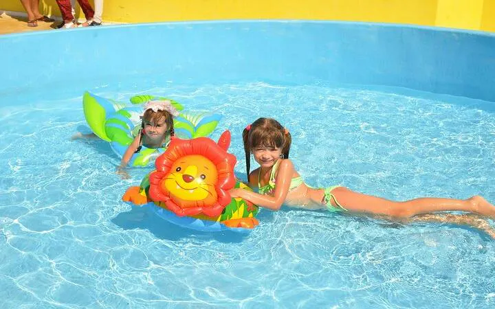 Children playing in a pool with inflatable toys during a sea trip in Hurghada.