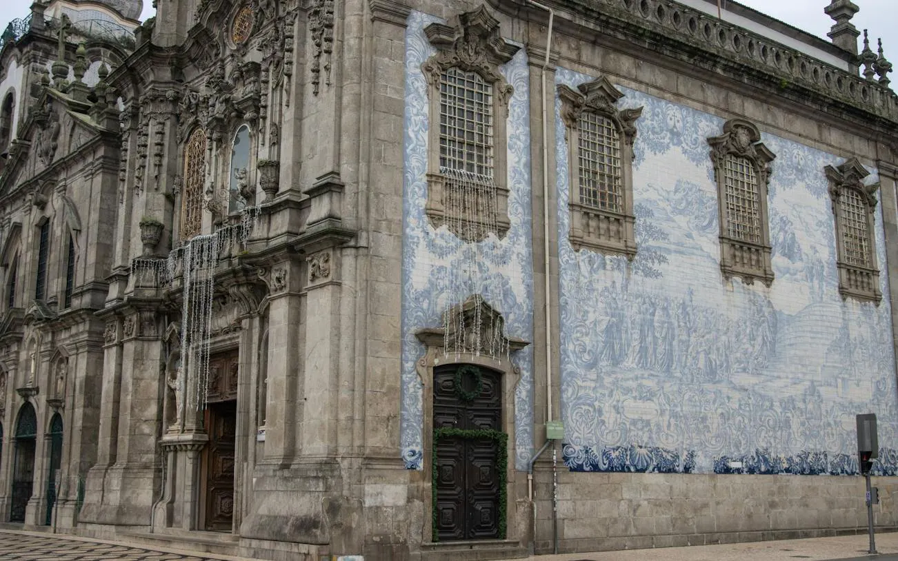 Baroque church facade with blue azulejo tiles in Porto's historic center.