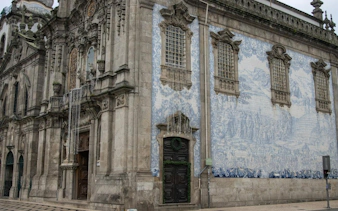 Baroque church facade with blue azulejo tiles in Porto's historic center.