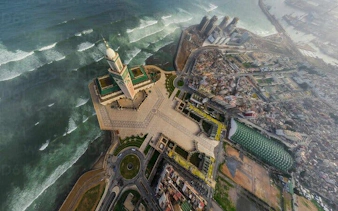 Aerial view of Hassan II Mosque and coastline in Casablanca during full-day excursion from Marrakesh.