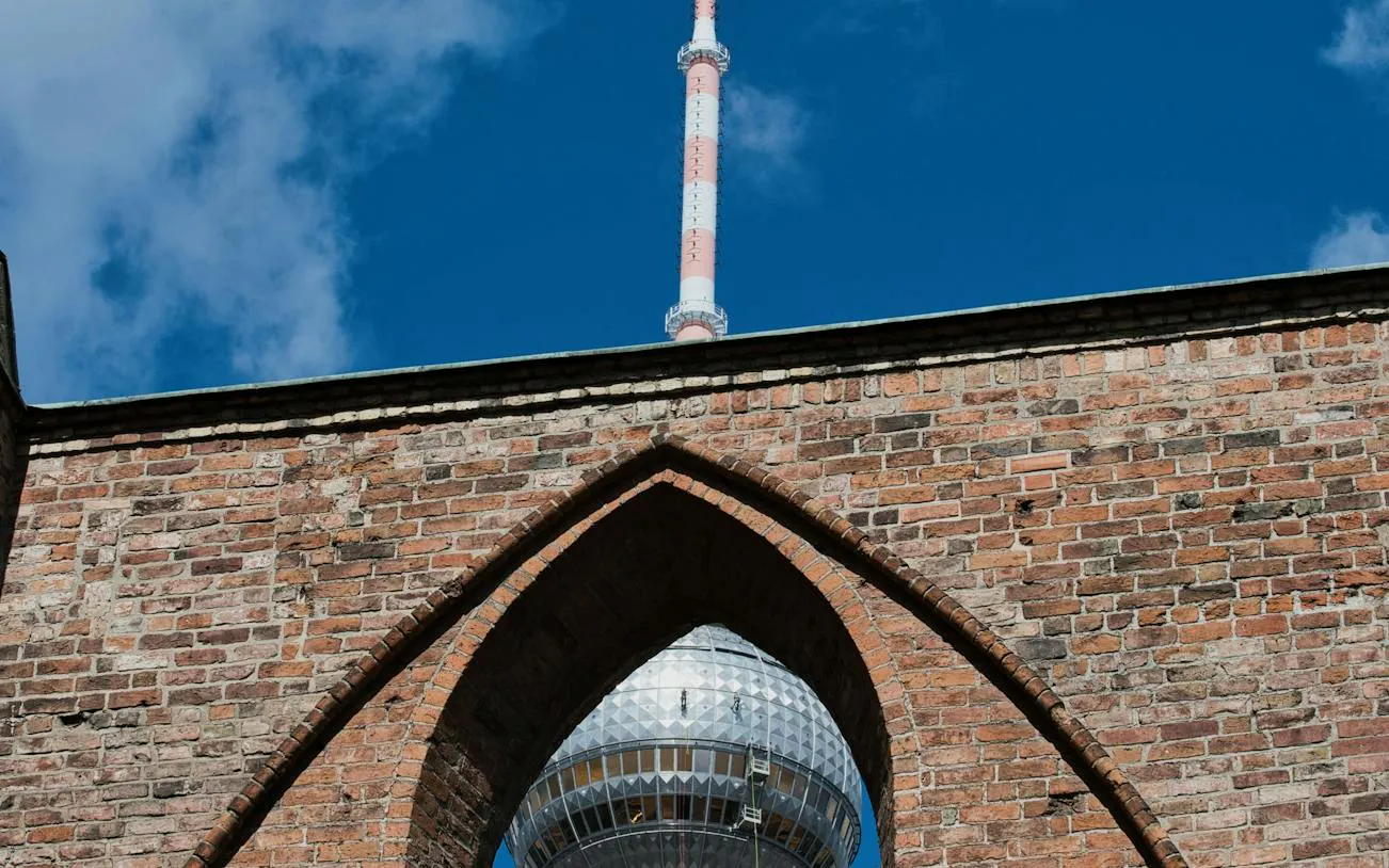 TV Tower seen through a brick arch in Berlin's Nikolaiviertel.