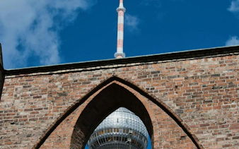 TV Tower seen through a brick arch in Berlin's Nikolaiviertel.