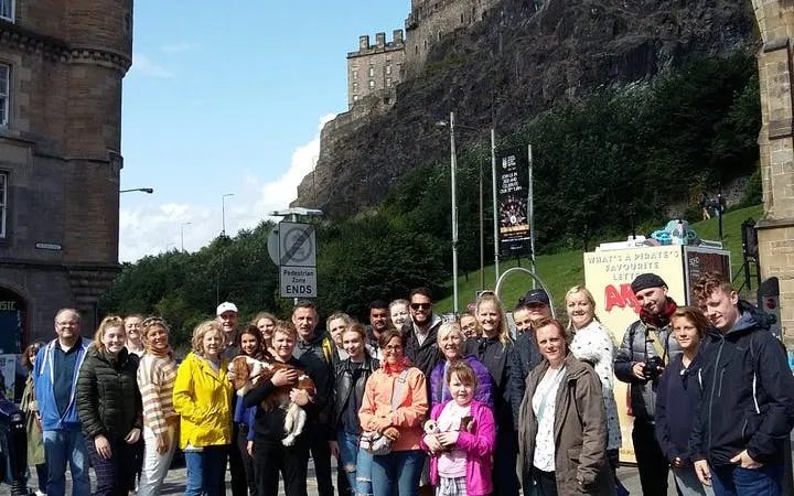 Group on Harry Potter walking tour in Edinburgh near historic castle.