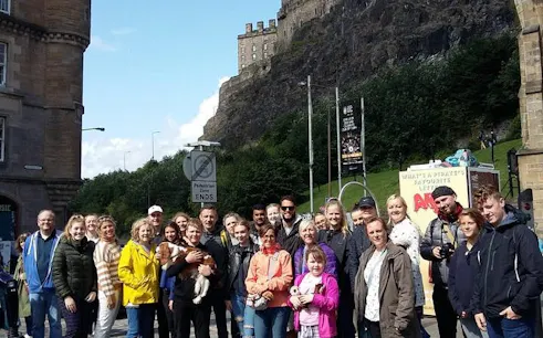 Group on Harry Potter walking tour in Edinburgh near historic castle.