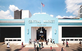 Central Market entrance in Kuala Lumpur with visitors walking nearby.