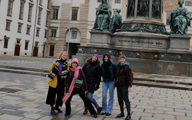 Group of people in front of a statue at Hofburg Palace, Vienna, during a self-guided city exploration game.