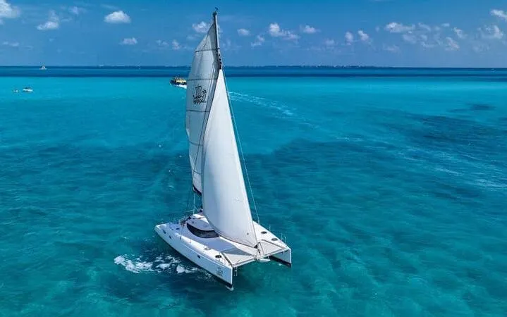 Catamaran sailing on turquoise waters near Isla Mujeres, Mexico.