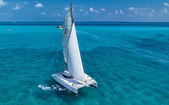 Catamaran sailing on turquoise waters near Isla Mujeres, Mexico.