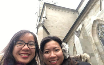 Zurich city exploration game participants near a historic church.