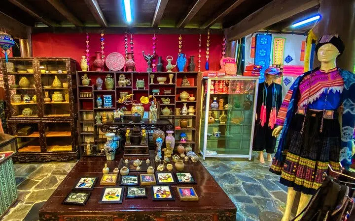 Sapa museum interior with traditional artifacts and ethnic clothing display.