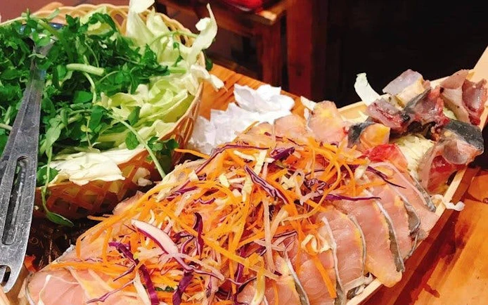 Sliced meats and fresh vegetables for hotpot meal on Sapa market tour.