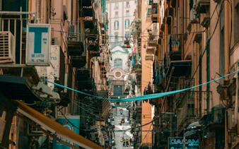 Narrow street in Naples Historic Center with view of Spaccanapoli and local architecture.