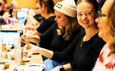 Dining experience on Shinjuku food tour with locals enjoying dishes in Tokyo.