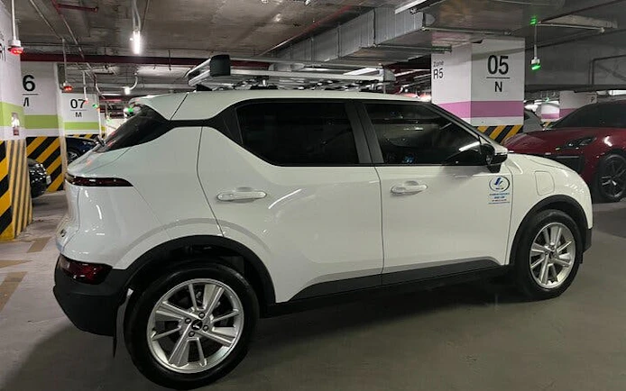 White SUV in a parking garage for Sapa to Ha Noi private car transfer.
