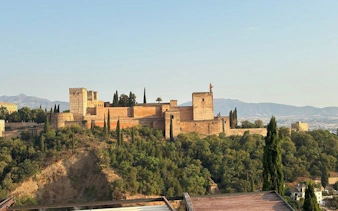 Alhambra fortress in Granada viewed from a distance, part of a self-guided walking tour.